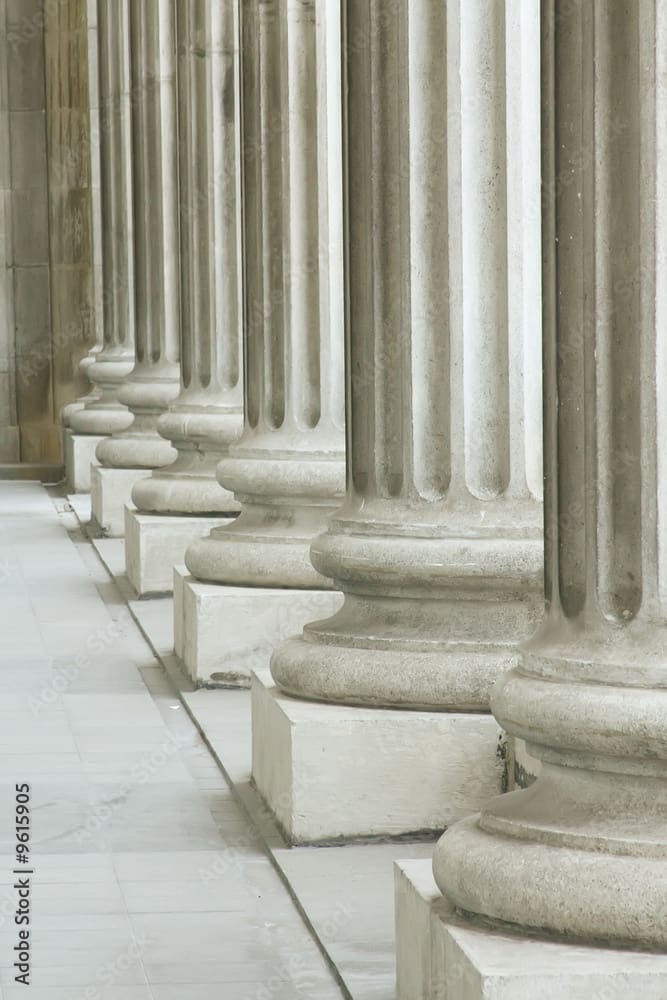 A row of pillars in the middle of a building.